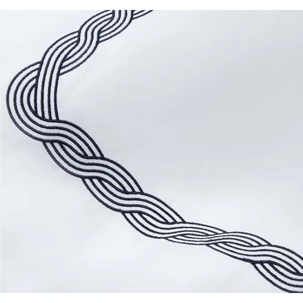 White Fabric with Black Braided Design